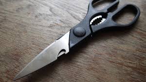 D&eacute;tail de la partie dentel&eacute;e entre les poign&eacute;es de ciseaux de cuisine