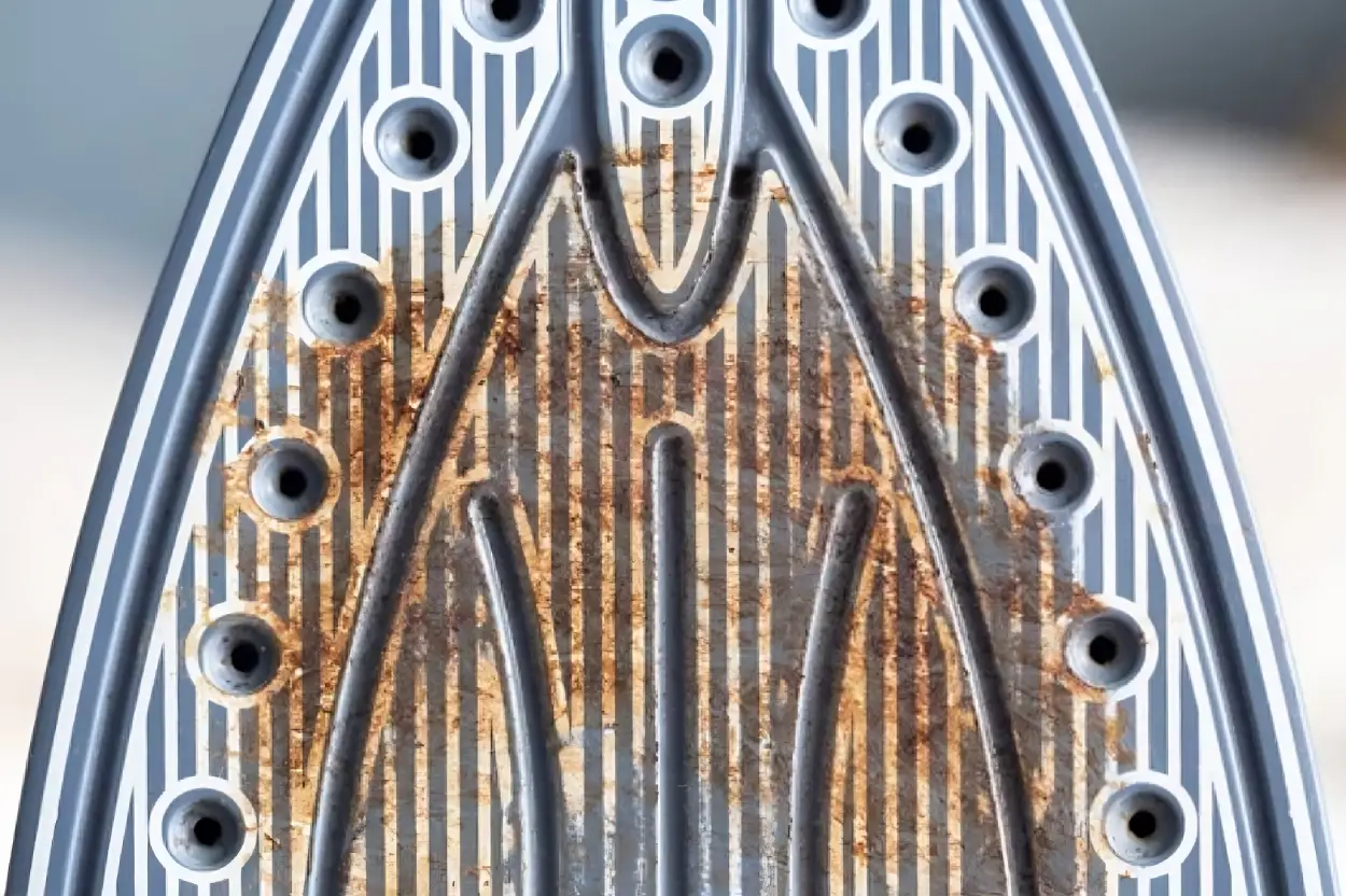 Semelle d'un fer à repasser noircie et encrassée