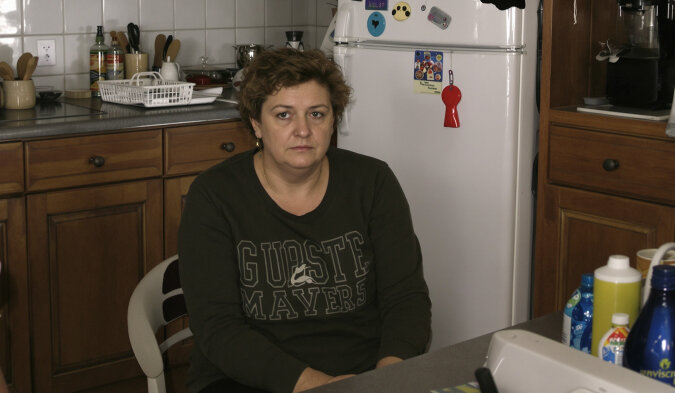 Femme regardant par la fenêtre, pensive